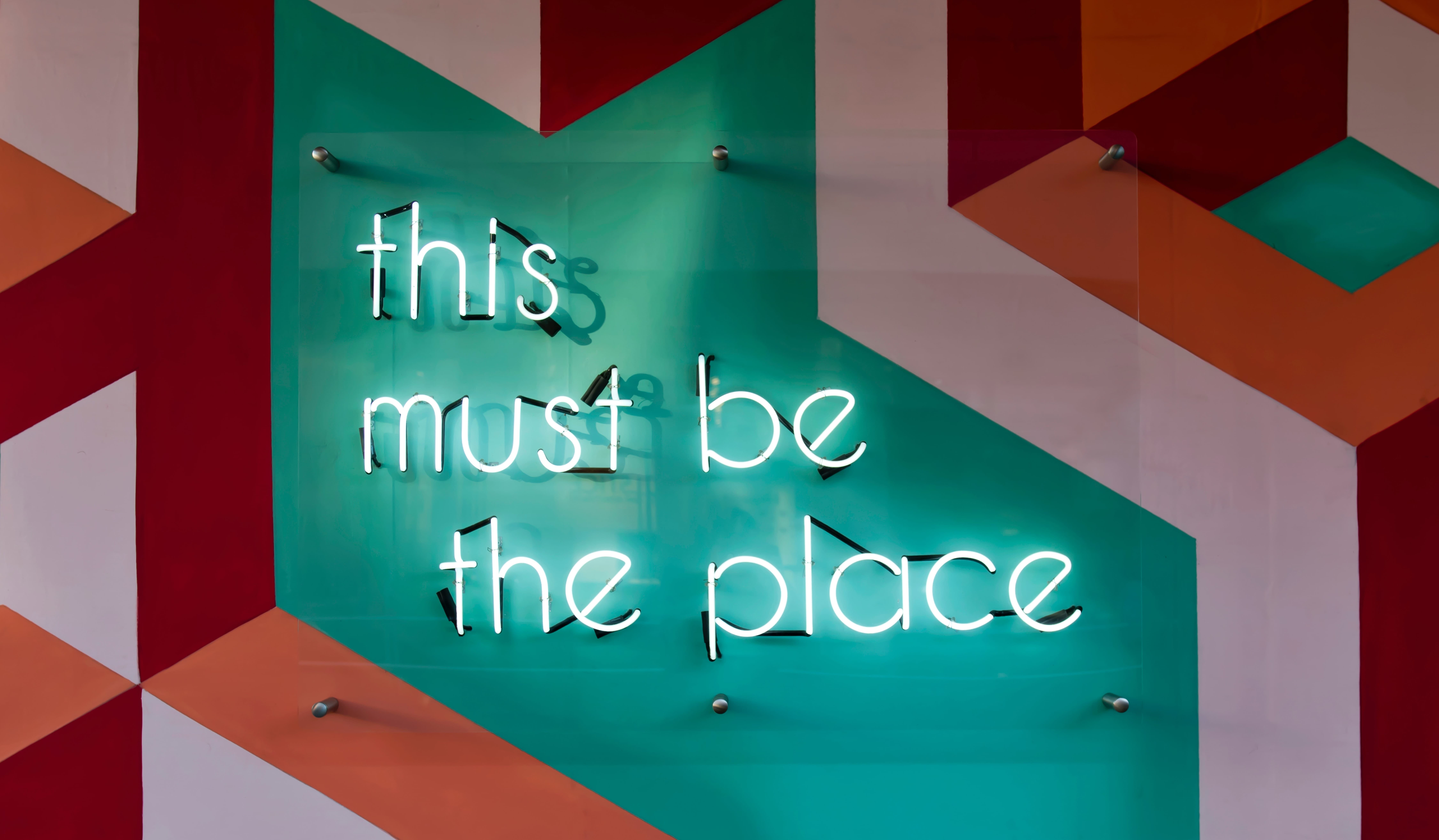 Sign in lights that says this must be the place